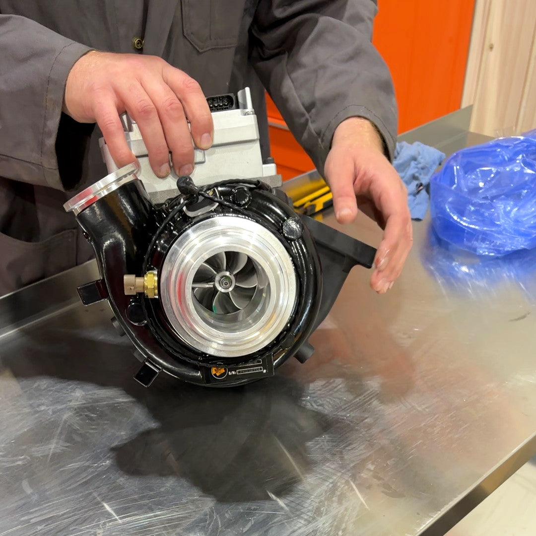 Hack Nation X15 Stage 1 Turbo NEW VGT w/ Actuator (HN-C5459711) held on bench, compressor side